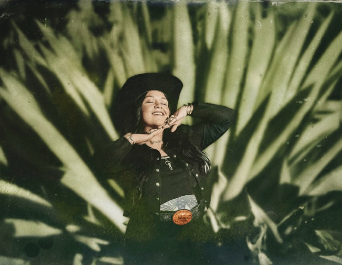 Buffalo Exchange employee Christina standing in front of a backdrop