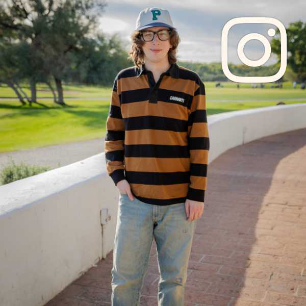 Person in a contemporary outfit of a Pirates baseball hat, striped Carhartt rugby polo, light wash jeans and color-tinted sunglasses. Instagram logo overlay at top. Person in a contemporary outfit of a Pirates baseball hat, striped Carhartt rugby polo, light wash jeans and color-tinted sunglasses. Instagram logo overlay at top.